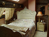 Views of the prettily decorated French Louis style double bedroom