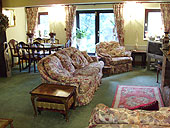  Views of the traditional beamed lounge with country style floral furnishings